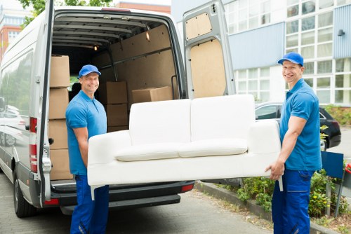 Moving team preparing items safely before loading a van