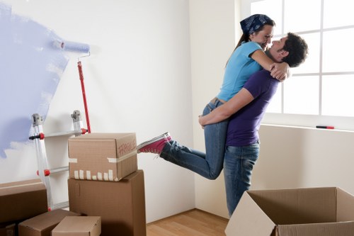 Packed moving boxes and wrapped furniture ready for transport in Islington