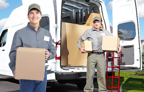 Removal staff carrying a box carefully through a property