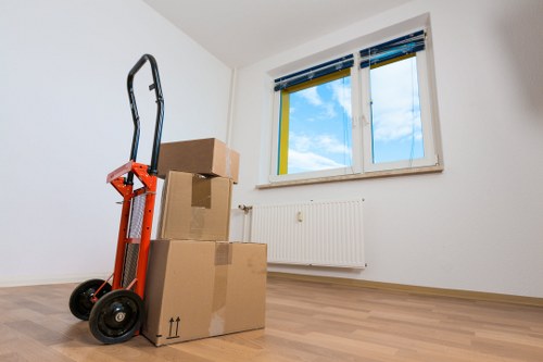 Packed moving boxes and furniture prepared for transport in Islington